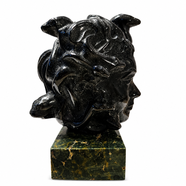 Bring mystical beauty to your space with this Labradorite Medusa Statue, featuring a polished dark stone finish and distinctive sculptural details. Labradorite is admired for its natural iridescent play-of-color and is traditionally associated with intuition, transformation, protection, and spiritual awareness.